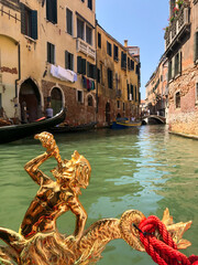 Gondola ride along the canals of Venice. Ancient houses, hot summer. City grand canal. Medieval...