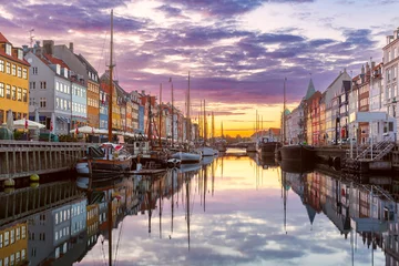 Fotobehang Nyhavn with colorful facades of old houses and ships in Old Town of Copenhagen, capital of Denmark. © Kavalenkava