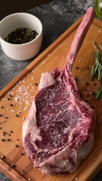 fresh tomahawk steak on rustic board