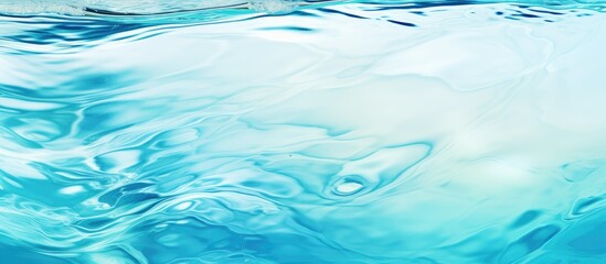 A closeup view of an azure blue water surface, creating a mesmerizing pattern that resembles a natural landscape in an ocean or pool