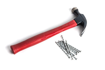 A carpenter's claw hammer with galvanized spiral framing nails isolated on white