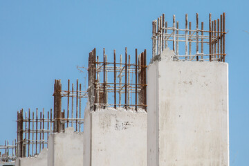 Poured concrete pillars in a high rise construction project showing rebar reinforcing steel
