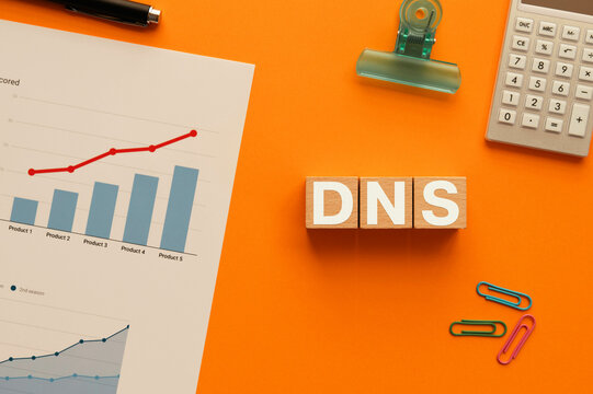 There is wood cube with the word DNS. It is an abbreviation for Domain Name System as eye-catching image.