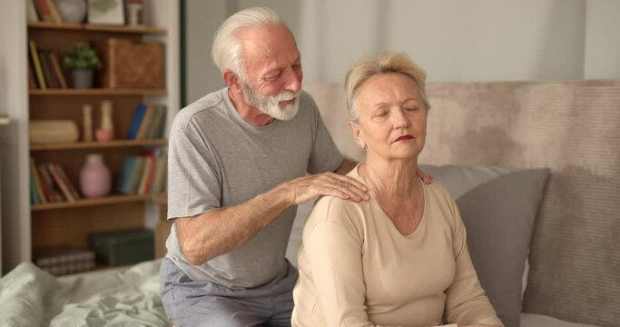 Senior mam massaging his wife in bed