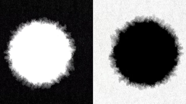 Black and White circles in the shape of rough inks lines on a black and white background made of craft paper