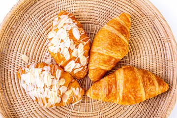 Almond croissants on basket with white background. Image on top view.