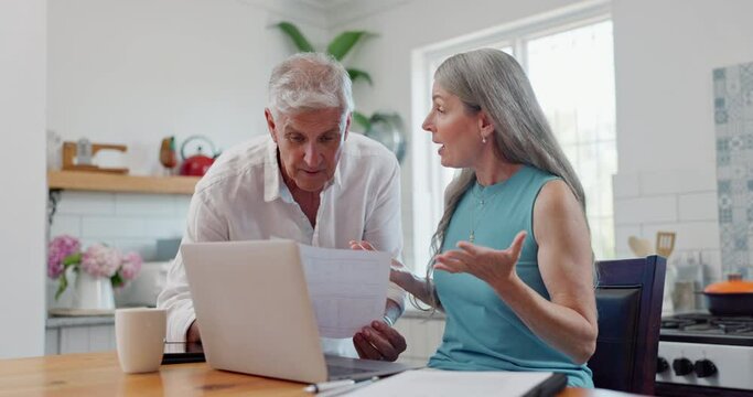 Laptop, argument and couple with document in kitchen for paying bills, mortgage or debt online. Fighting, stress and mature man and woman with paperwork and computer for internet payments at home.