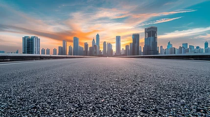 Fotobehang A panoramic skyline showcases modern commercial buildings alongside an empty road, with the asphalt gleaming under the soft glow of the sunrise.  © Marry