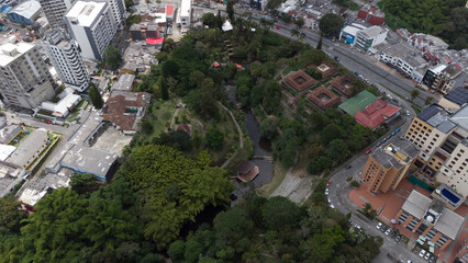 Aerial view of the city of Armenia, Quindío, Colombia. Buildings in the city of Armenia between trees. Park of life in Armenia, Quindío