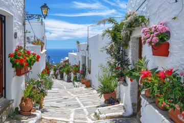 Fototapeta na wymiar Whitewashed Greek alley flowerpots sea view