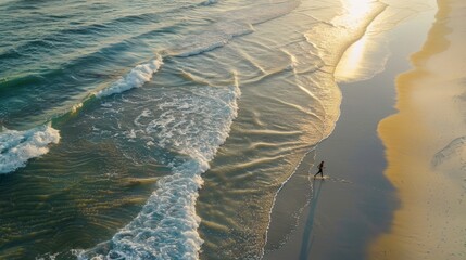 A view from above of a jogger running along a white beach at sunrise, the ocean waves crashing in the background