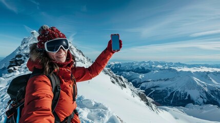 A woman snowboarder taking a selfie on top of a mountain, capturing the panoramic vista behind her 