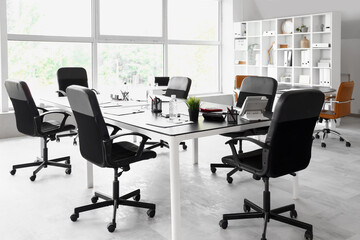 Interior of conference room with desks and shelf unit