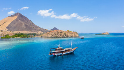 Aerial view of beaches and tourist boat sailing in Kelor Island, Flores Island, Indonesia