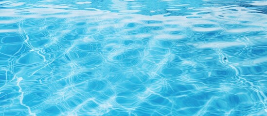 Obraz premium A close up of the azure liquid in a swimming pool, showcasing the intricate pattern of wind waves under the electric blue sky