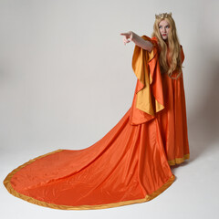 Full length portrait of plus sized woman blonde hair, wearing historical medieval fantasy gown with...