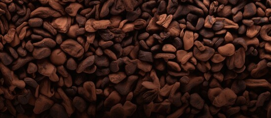 Capture the detailed view of a mound of roasted coffee beans in this image - obrazy, fototapety, plakaty