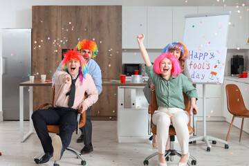 Business people celebrating April Fools' Day in kitchen at office party