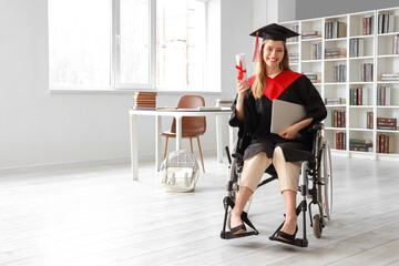 Fototapeta na wymiar Female graduate in wheelchair with laptop and diploma at university