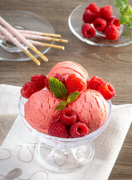 Raspberry ice cream in the bowl.
