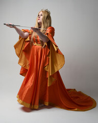 Full length portrait of plus sized woman blonde hair, wearing historical medieval fantasy gown,...