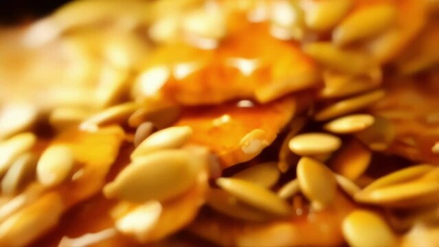 An enticing closeup shot revealing a beautiful pile of roasted pumpkin seeds, bathed in a flavorful mixture of tamari sauce, honey, and a touch of Worcestershire, creating a perfect balance