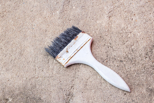 Paint brush on the cement floor