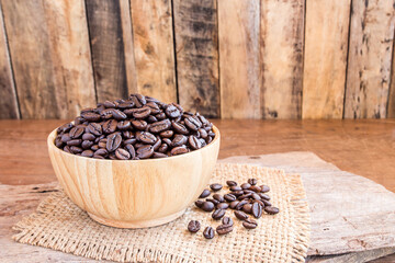 Roasted coffee beans in a wooden bowl