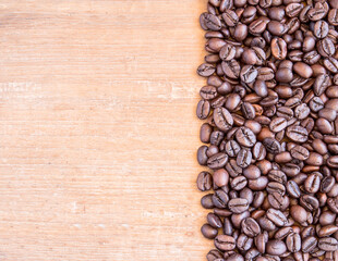 Coffee beans on wooden table background