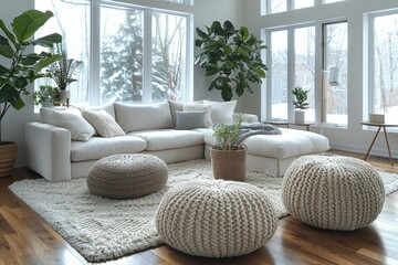 A spacious, snowy view through large windows complementing a modern white sofa and soft pouffes in a clean living room. - obrazy, fototapety, plakaty