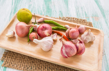 Organic red onion garlic and lemon on wooden background