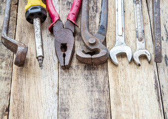 Close up bunch of used tools on wooden background