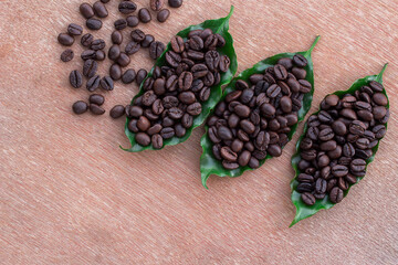 Close up coffee beans and fresh green leaf