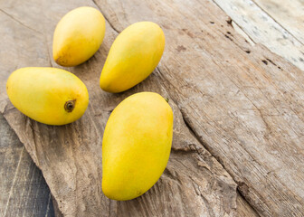 Ripe mango on the wooden floor