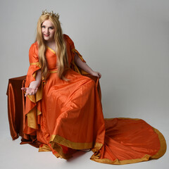 Full length portrait of plus size blonde woman, wearing historical medieval fantasy gown, golden...
