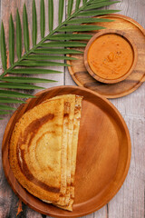 South Indian food set dosa with tomato chutney. Also called nice set dosa. Homemade Dosa, dhosa, masala, plain, maisuri (Ghee Roast) with Chutney. Common Indian breakfast.