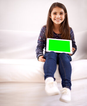 Portrait, green screen or child with tablet for mockup, playing games or streaming videos on movie website. Space, house or happy kid with smile or technology to download on social media app on sofa