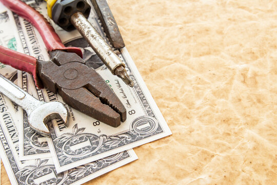 dollar banknotes and tools on old paper background