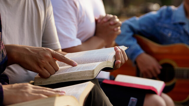 Christian Bible pray Concepts. Christian friend's groups read,study and pray the bible together in a home with window light. followers are studying the word of God in churches.