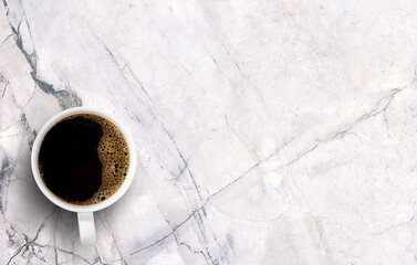 black coffee in white cup on white marble background