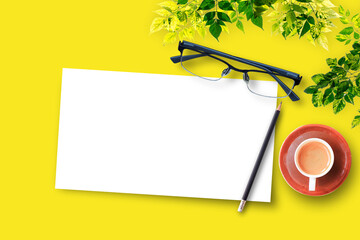 Blank white paper on yellow table background, top view with copy space.