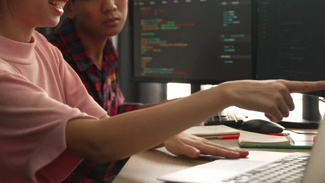 Back end software developer engineer for computer programming working together on debugging writing computing code, solving complex algorithms display on monitor in office. Burgeoning