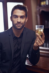 Portrait, alcohol and businessman indoor to relax and formal fashion for professional in city. Entrepreneur, face and person with glass of whisky for rest, drink and ambition in startup career