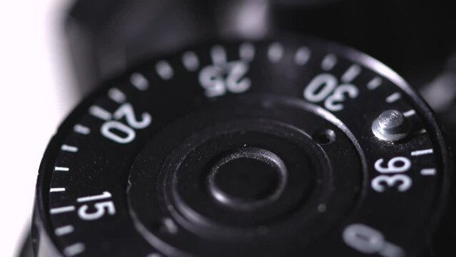 Smooth close up rotation of frame counter dial of old vintage analog photo camera