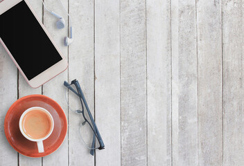 Coffee cup and smart phone on wood background.
