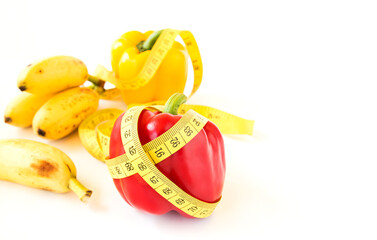 Yellow tape measure and sweet pepper on white background.