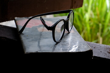 glasses and books are in the window frames