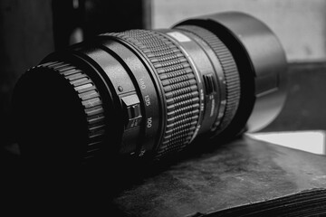 telephoto lens for a DSLR sits in the window frame