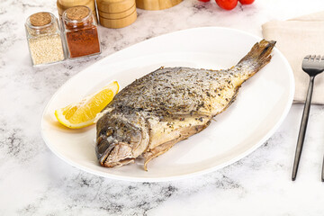 Baked Dorado fish served lemon
