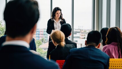 In an office meeting, business professionals collaborate. Seated team members share their insights, while male and female managers stand, guiding the productive discussion.